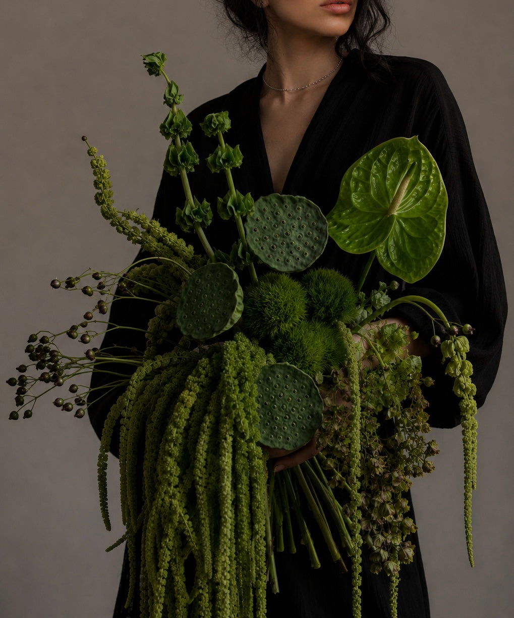 Editorial green floral bouquet featuring sculptural foliage and natural textures