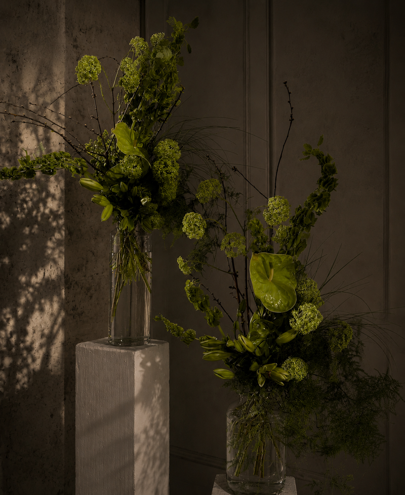 Sculptural green floral arrangements with contemporary styling and seasonal materials