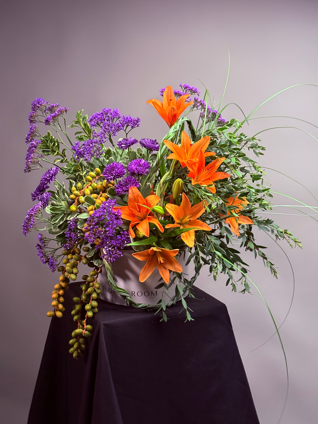 Kinetic Line floral box arrangement with orange lilies and purple limonium by The Floral Room