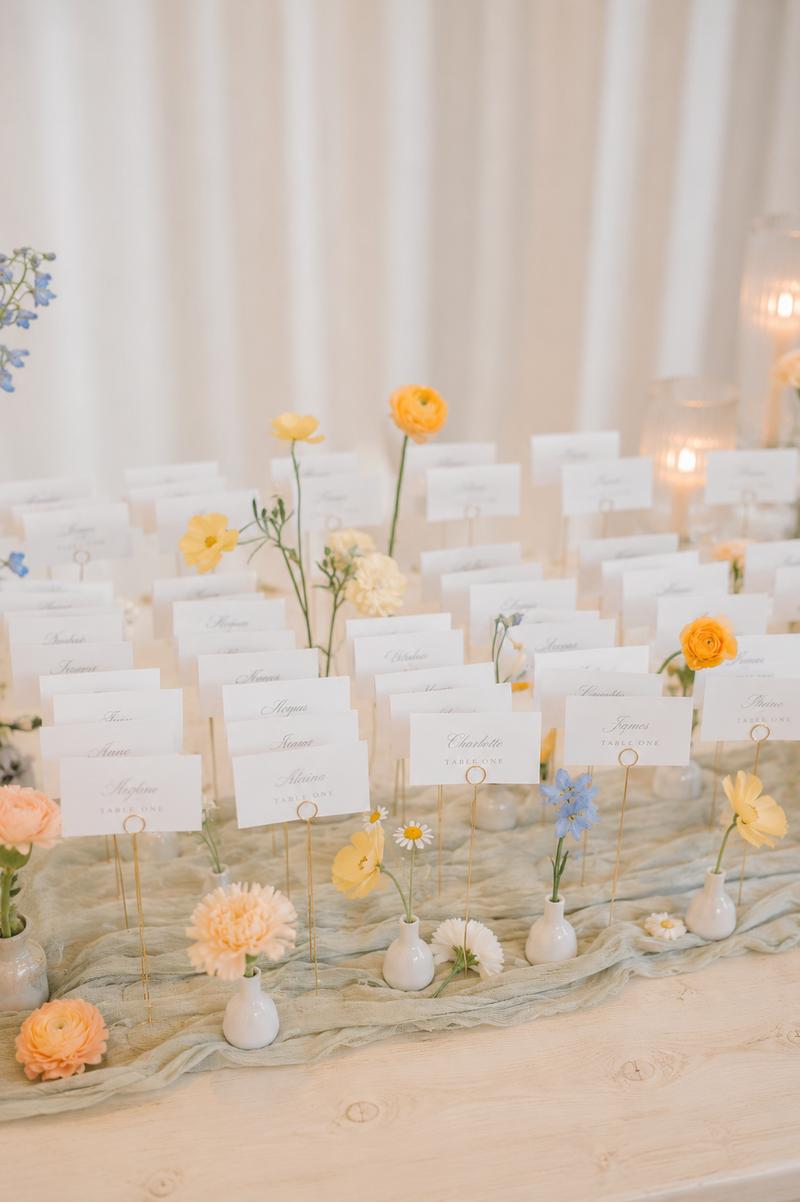 Wedding place cards surrounded by seasonal florals